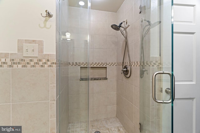 full bath featuring a shower stall