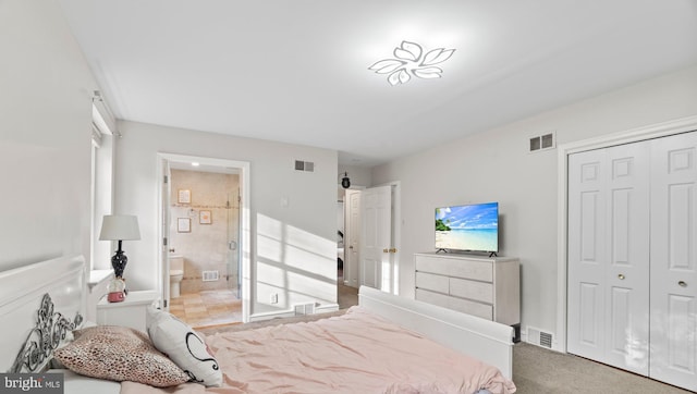 bedroom with visible vents, connected bathroom, and a closet