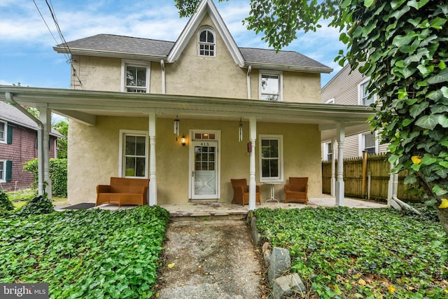 415 Schwartz Ave, Baltimore, MD 21212 - view of front of house featuring stucco siding and a porch