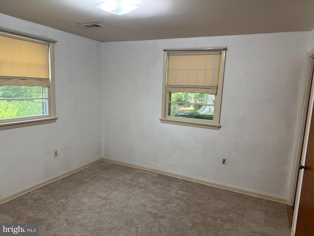 empty room with carpet and baseboards