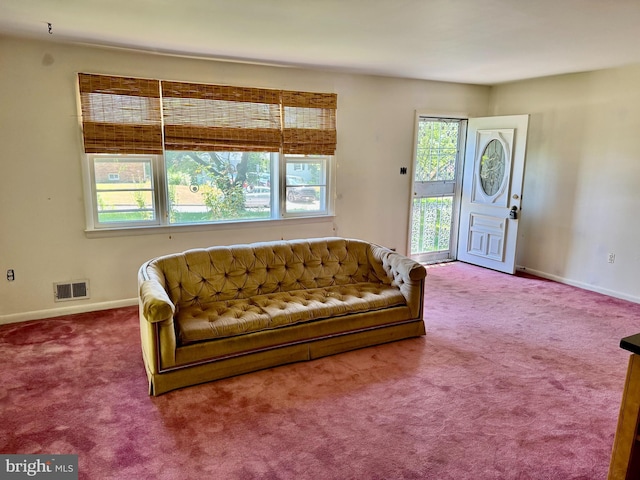 living area featuring carpet flooring and baseboards