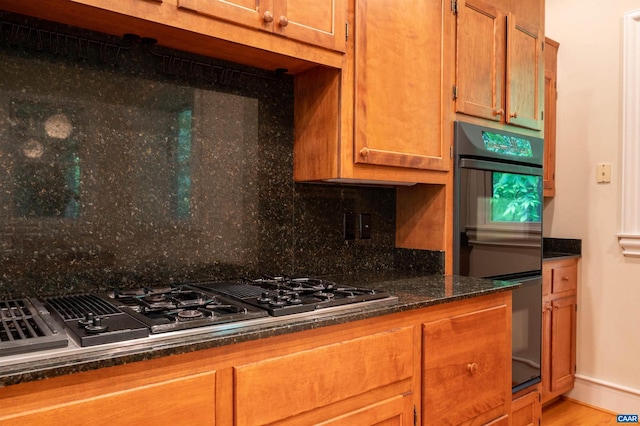 481 Stoney Creek E, Nellysford, VA 22958 - kitchen featuring dobule oven black, brown cabinetry, stovetop with downdraft, baseboards, and decorative backsplash