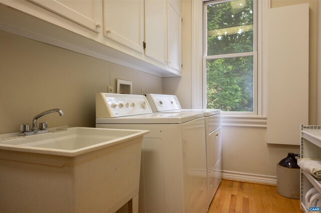 481 Stoney Creek E, Nellysford, VA 22958 - laundry area with cabinet space, washing machine and dryer, a sink, and light wood-type flooring