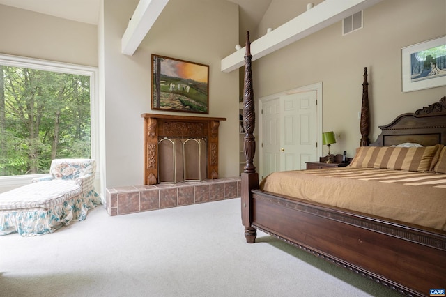 481 Stoney Creek E, Nellysford, VA 22958 - bedroom featuring visible vents, a high ceiling, carpet floors, and a tiled fireplace