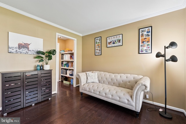 sitting room featuring wood finished floors, ornamental molding, and baseboards