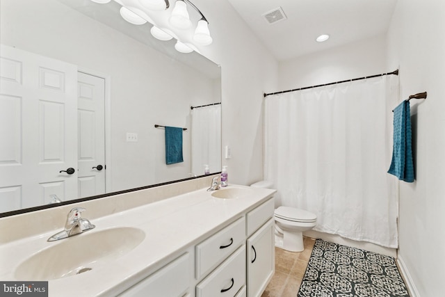 full bathroom featuring toilet, double vanity, a sink, and visible vents