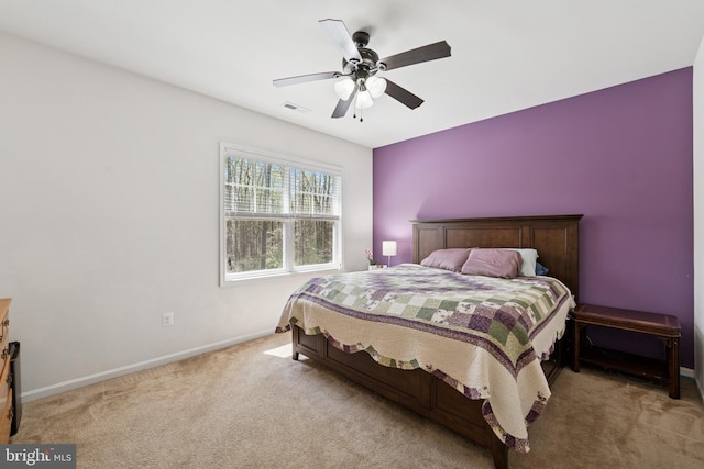 bedroom featuring baseboards, visible vents, a ceiling fan, and carpet