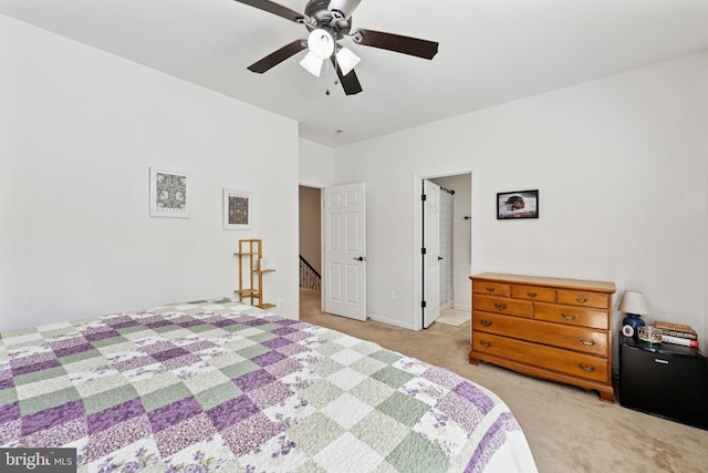bedroom with baseboards, ceiling fan, and light colored carpet