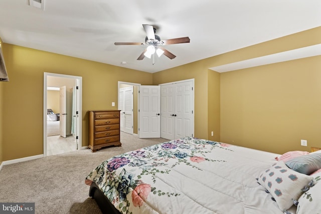carpeted bedroom with baseboards, visible vents, ceiling fan, and a closet