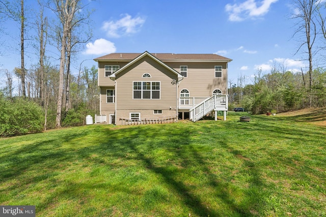 back of house with a wooden deck and a yard