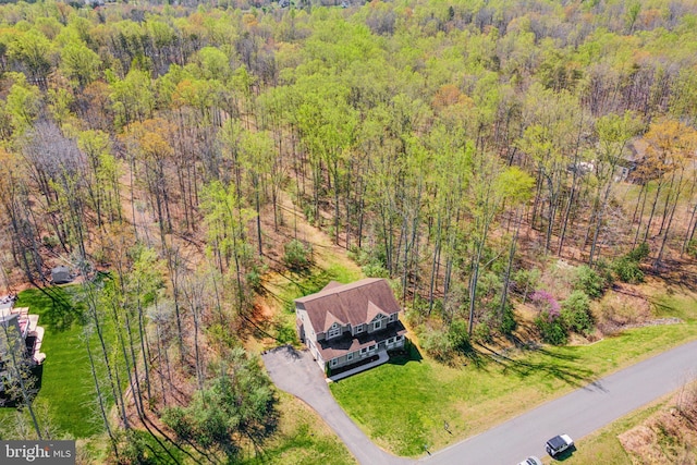 birds eye view of property with a wooded view