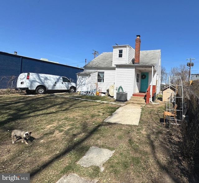 3207 Randall Rd, Suitland, MD 20746 - rear view of property with roof with shingles, a yard, a chimney, and cooling unit
