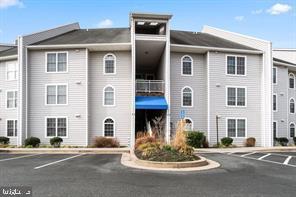 view of building exterior featuring uncovered parking