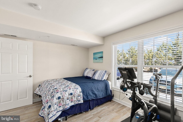 bedroom with baseboards and light wood-style floors