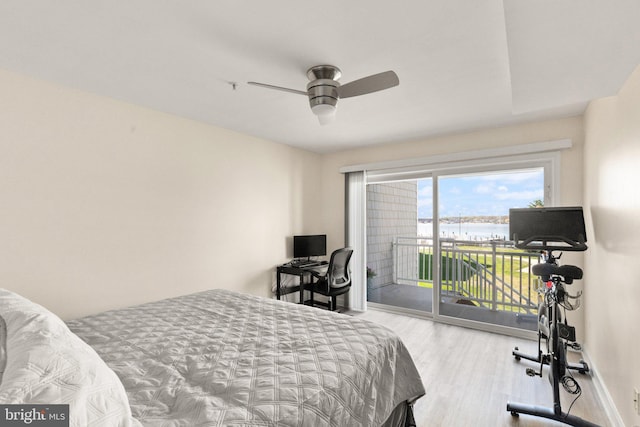 bedroom featuring ceiling fan, access to exterior, wood finished floors, and baseboards
