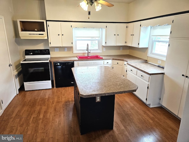 kitchen with white cabinetry, dark wood-style flooring, a sink, electric range oven, and dishwasher
