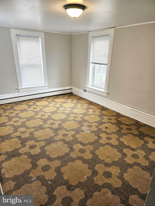 spare room with a baseboard radiator and carpet