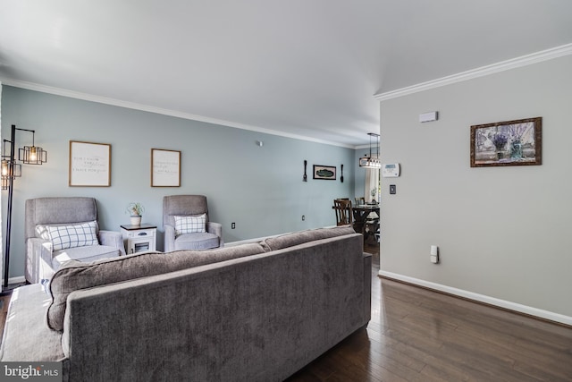 living area with crown molding, dark wood-style flooring, and baseboards