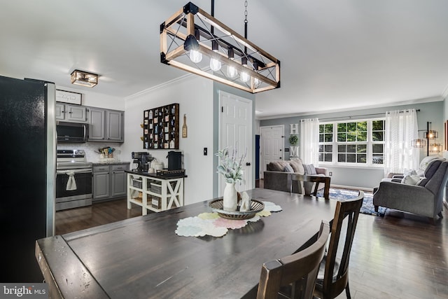 dining space featuring crown molding and dark wood-style floors