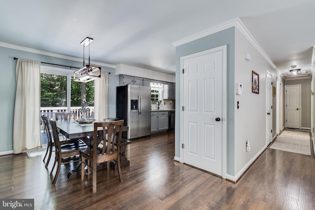 dining space featuring baseboards, dark wood-style floors, and ornamental molding