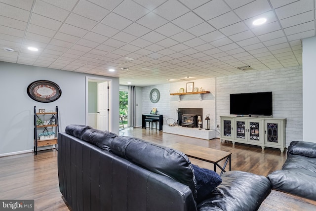 living area featuring baseboards, visible vents, and wood finished floors