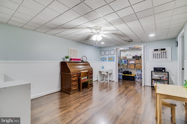 home office featuring visible vents, a ceiling fan, wainscoting, and wood finished floors