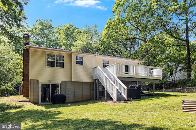 back of house with brick siding, a wooden deck, stairway, a chimney, and a lawn