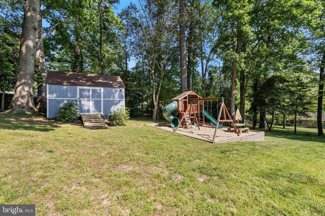 view of yard with an outbuilding, a playground, and a storage unit