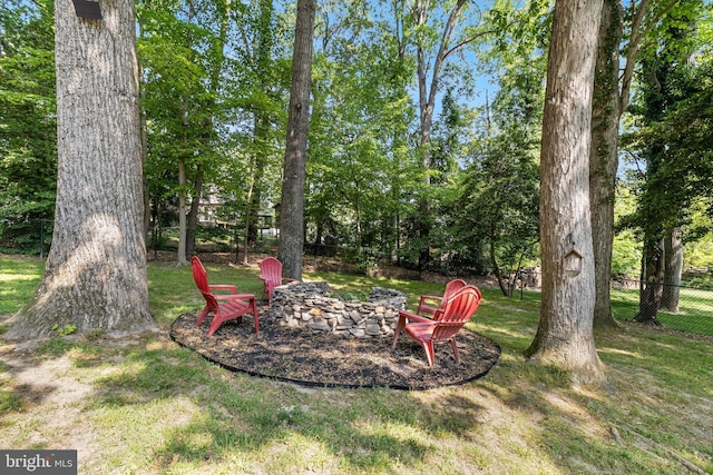 view of yard featuring fence and a fire pit