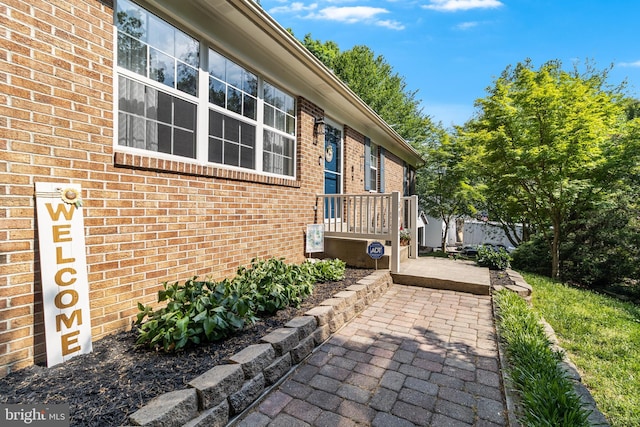 view of side of home with brick siding