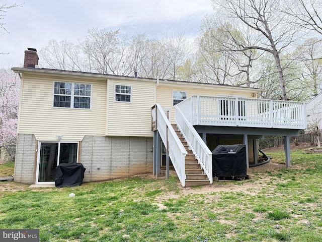 back of property with stairs, a chimney, a yard, and a deck