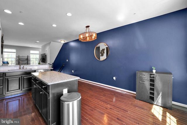 kitchen featuring recessed lighting, baseboards, dark wood-type flooring, and dark cabinetry