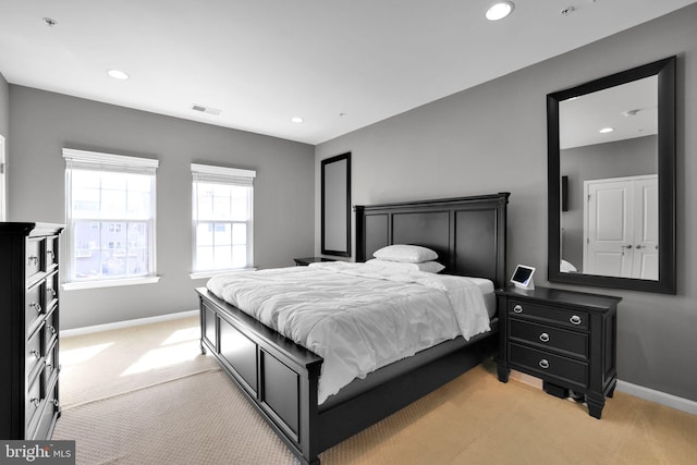 bedroom with recessed lighting, baseboards, and light carpet