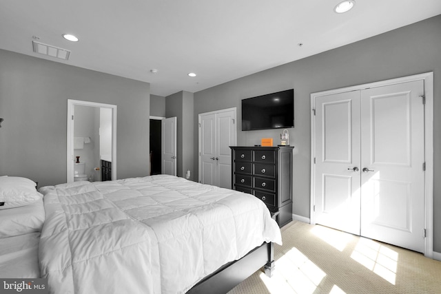 bedroom featuring recessed lighting, visible vents, light carpet, baseboards, and two closets