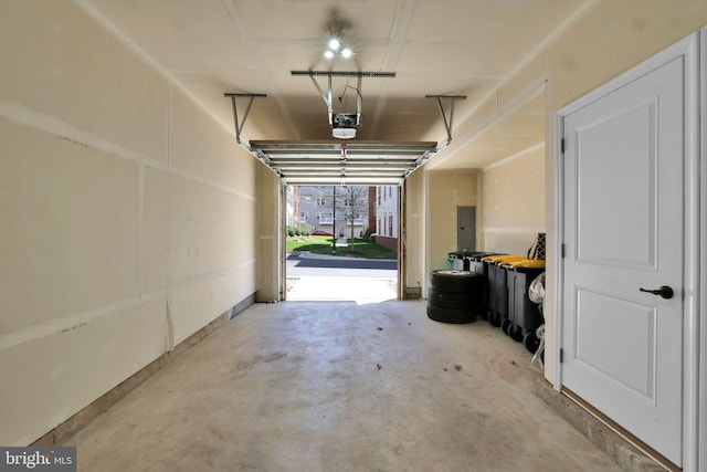 garage featuring a garage door opener and electric panel