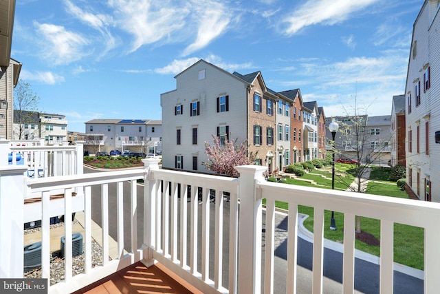 balcony with a residential view and central AC unit