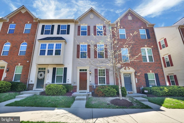 townhome / multi-family property featuring brick siding