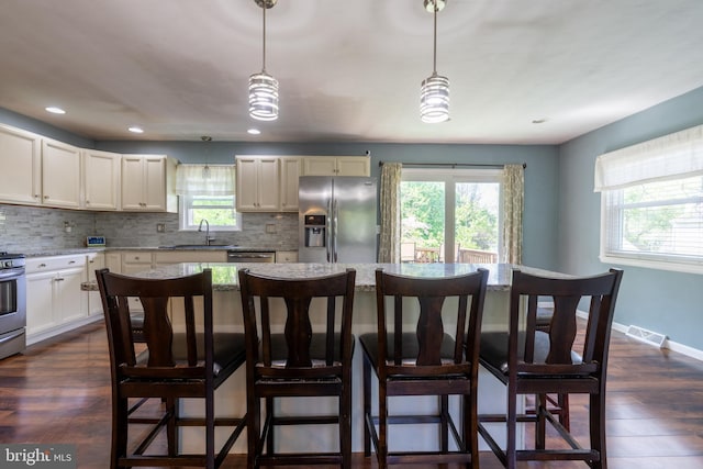 3305 Baker Ct, Altoona, PA 16602 - kitchen featuring appliances with stainless steel finishes, backsplash, a breakfast bar area, and recessed lighting