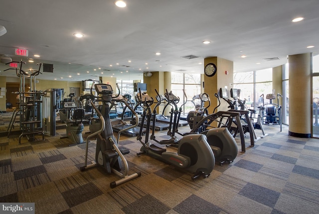 exercise room featuring carpet flooring, recessed lighting, expansive windows, and visible vents