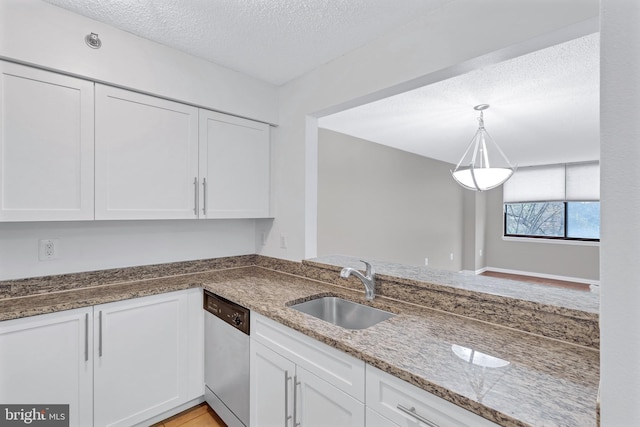 kitchen with dishwasher, a sink, white cabinetry, and stone countertops