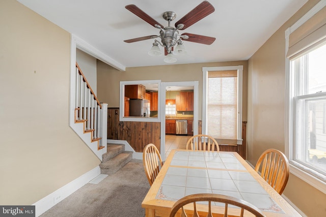 dining space featuring baseboards, a wealth of natural light, and ceiling fan
