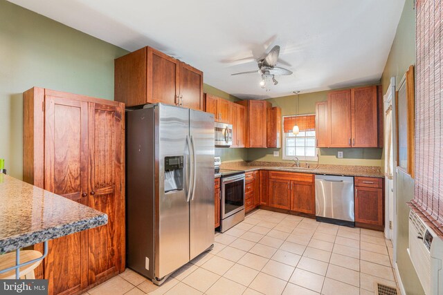 kitchen featuring a sink, light tile patterned flooring, a ceiling fan, visible vents, and appliances with stainless steel finishes
