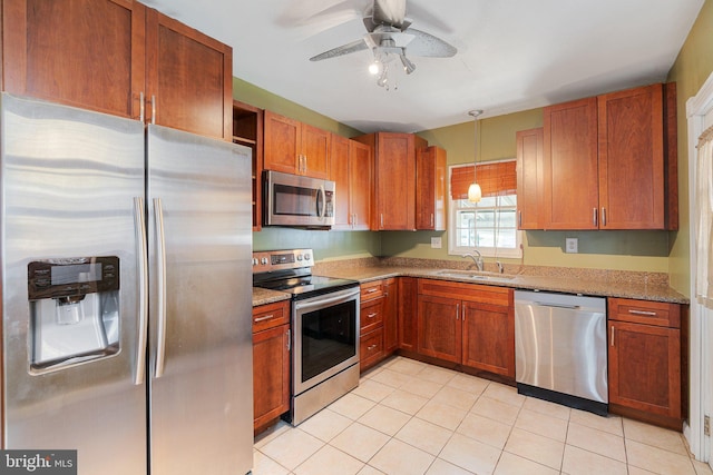 kitchen with stainless steel appliances, a ceiling fan, light stone counters, and a sink