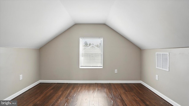 5427 Gradin Ave, Gwynn Oak, MD 21207 - additional living space with dark wood-style flooring, baseboards, visible vents, and lofted ceiling