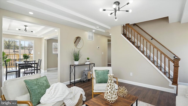5427 Gradin Ave, Gwynn Oak, MD 21207 - living area with visible vents, an inviting chandelier, recessed lighting, wood finished floors, and stairs