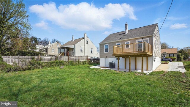 5427 Gradin Ave, Gwynn Oak, MD 21207 - back of house featuring central AC unit, a yard, a chimney, fence, and a wooden deck