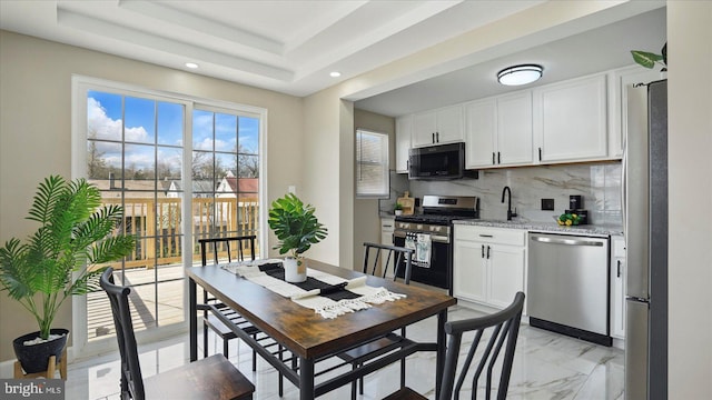 5427 Gradin Ave, Gwynn Oak, MD 21207 - kitchen featuring appliances with stainless steel finishes, marble finish floor, white cabinetry, and light stone countertops