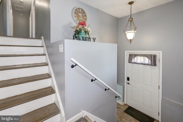 tiled foyer entrance with baseboards