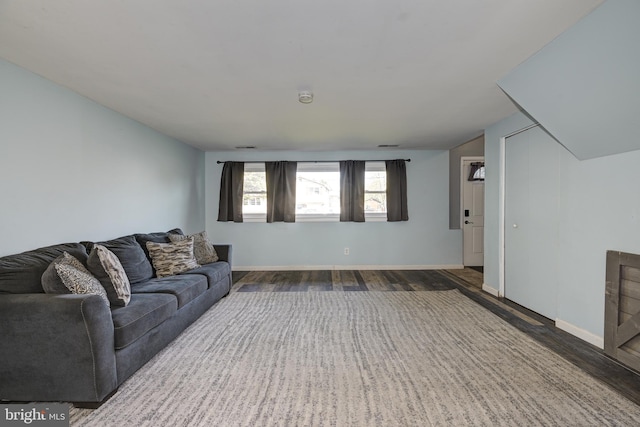 living area featuring baseboards and wood finished floors
