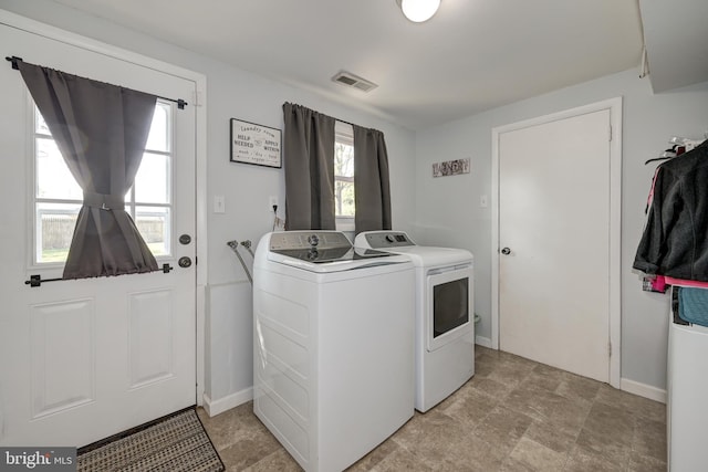 laundry room with washer and dryer, laundry area, visible vents, and plenty of natural light